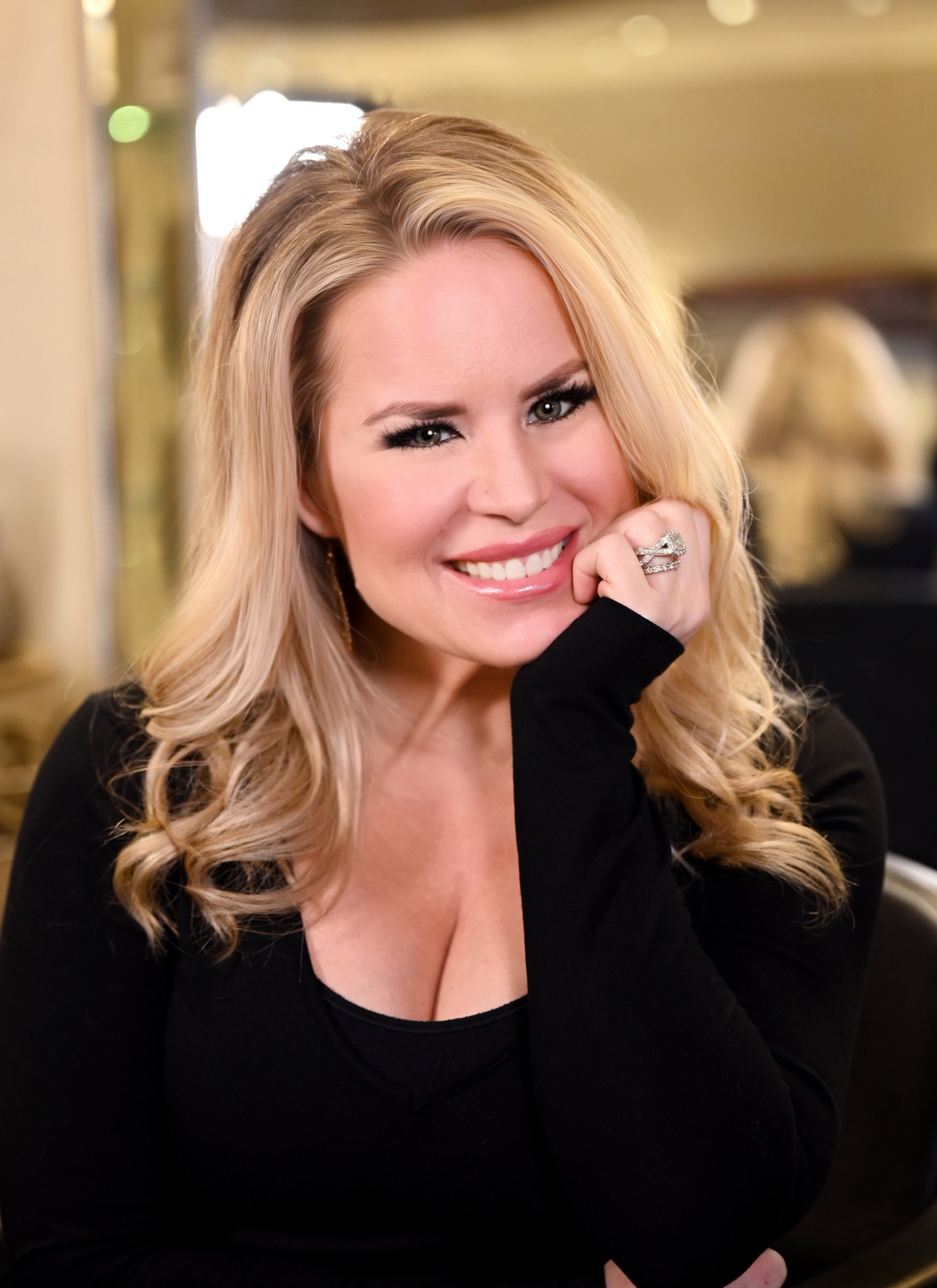Janelle Alexis close-up salon portrait with warm smile — licensed cosmetologist and beauty authority Houston